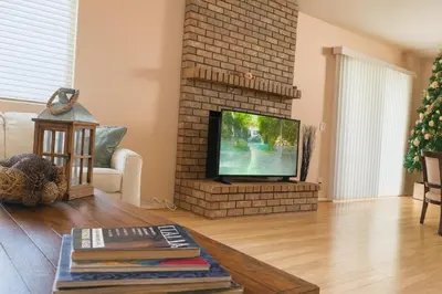 a living room with a fireplace and a tv at Starlight Western Room in Hemet