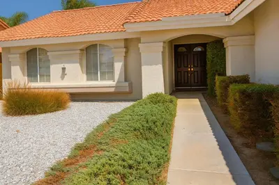a house with an orange roof and a black door at Starlight Western Room in Hemet