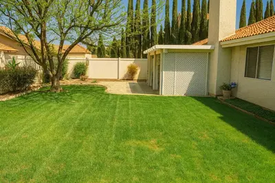 a yard with a green lawn in front of a house at Starlight Western Room in Hemet
