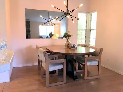 a dining room with a table and chairs and a mirror at Stallion Crest Suite with TV and private bathroom in Hemet