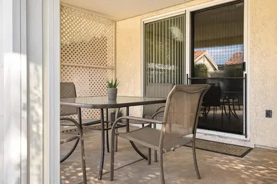 a table and chairs on a balcony with a piano at Stallion Crest Suite with TV and private bathroom in Hemet