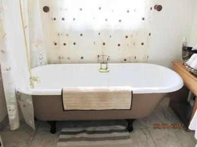 a white bath tub in a bathroom with a window at Historical Cabin in Julian Pet's okay! in Julian
