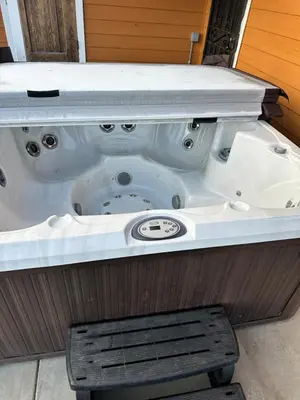 a jacuzzi tub with a bench in the middle at A LIVING CANVAS Amazing Lake View Custom Home in Julian