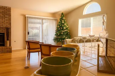 a living room with a christmas tree and a table and chairs at Sundance Retreat in Hemet