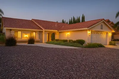 a large house with a garage at night at Sundance Retreat in Hemet