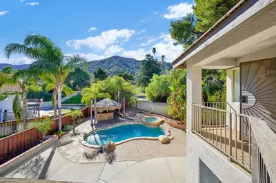 a house with a swimming pool on a balcony at Pool-BBQ-View-Balcony-Fireplace-King-Garage-WD in Lake Elsinore