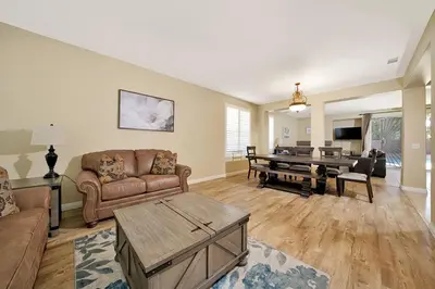 a living room with a couch and a table at Pool-BBQ-View-Balcony-Fireplace-King-Garage-WD in Lake Elsinore