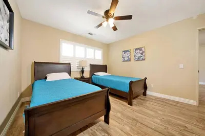 a bedroom with two beds and a ceiling fan at Pool-BBQ-View-Balcony-Fireplace-King-Garage-WD in Lake Elsinore
