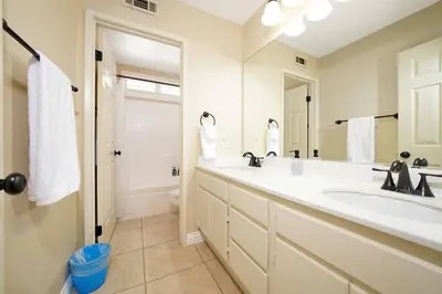 a bathroom with a sink and a toilet and a mirror at Pool-BBQ-View-Balcony-Fireplace-King-Garage-WD in Lake Elsinore
