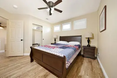 a bedroom with a bed and a ceiling fan at Pool-BBQ-View-Balcony-Fireplace-King-Garage-WD in Lake Elsinore
