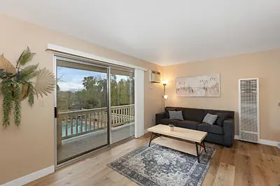 a living room with a couch and a table at Charming 2 Room La Mesa Casita w/ Pool, BBQ & Yard in La Mesa