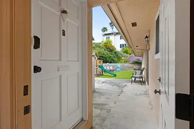 an open door to a yard with a playground at Charming 2 Room La Mesa Casita w/ Pool, BBQ & Yard in La Mesa