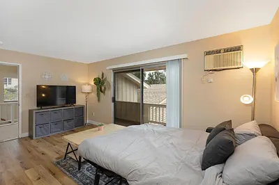 a bedroom with a bed and a flat screen tv at Charming 2 Room La Mesa Casita w/ Pool, BBQ & Yard in La Mesa