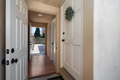 a hallway of a home with a white door at Charming 2 Room La Mesa Casita w/ Pool, BBQ & Yard in La Mesa