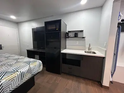 a small kitchen with a sink and a refrigerator at Studio 6 Hemet, CA in Hemet