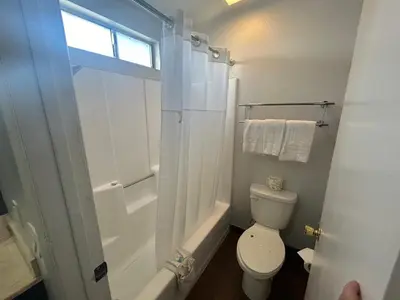 a white bathroom with a toilet and a shower at Studio 6 Hemet, CA in Hemet