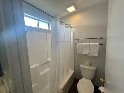 a bathroom with a toilet and a shower and a window at Studio 6 Hemet, CA in Hemet