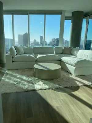 a living room with a white couch and a coffee table at Luxury Designer Suite with Rooftop Pool, Gym in San Diego