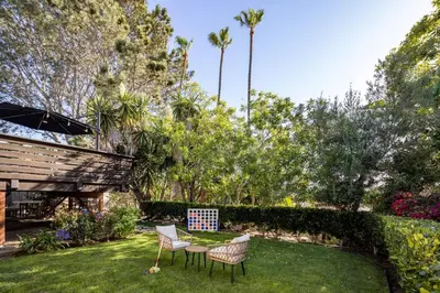 a yard with two chairs and a table with a checker board at Solana Beach House! Minutes to Dog Beach & Cedros in Solana Beach