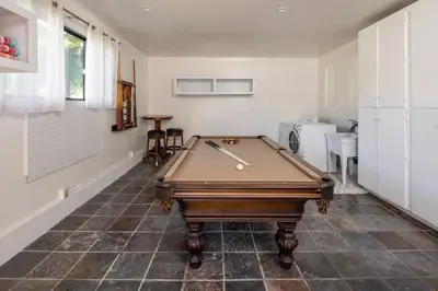 a room with a pool table on a tile floor at Solana Beach House! Minutes to Dog Beach & Cedros in Solana Beach
