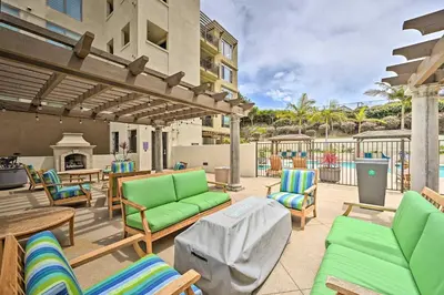 a patio with lounge chairs and a fireplace at Breezy Oceanside Condo Less Than half Mi to Beach! in Oceanside