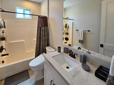 a bathroom with a sink and a toilet and a tub at Modern comfort, prime location, 360 views, 4 BR entire house in San Diego
