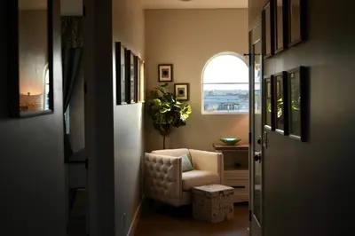 a hallway with a chair and a window at Modern comfort, prime location, 360 views, 4 BR entire house in San Diego