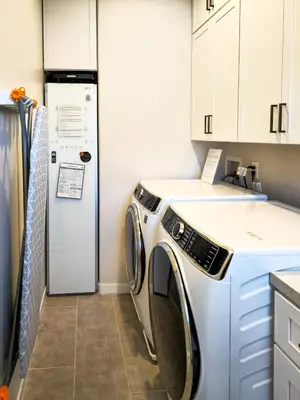 a washer and dryer in a kitchen with a refrigerator at Modern comfort, prime location, 360 views, 4 BR entire house in San Diego