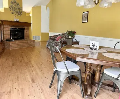 a living room with a table and chairs and a fireplace at Willow brook room with TV in Hemet