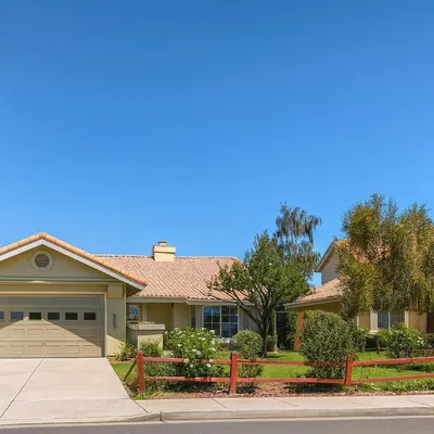 a house with a fence in front of it at Willow brook room with TV in Hemet