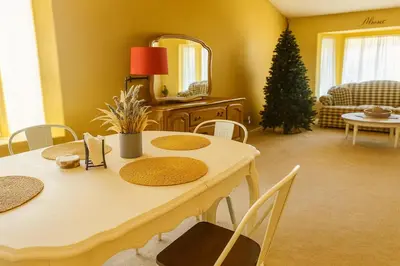 a dining room with a table and a christmas tree at Willow brook room with TV in Hemet
