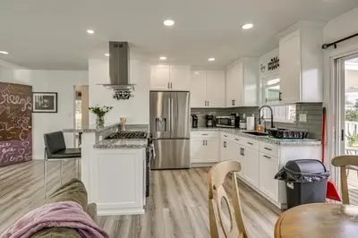 a kitchen with white cabinets and stainless steel appliances at Breeze by the Marina Chula Vista Getaway! in Chula Vista