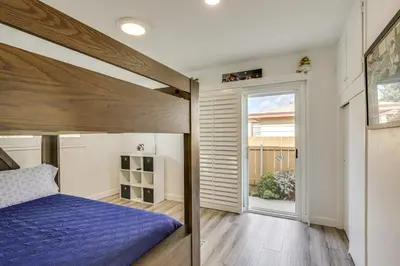 a bedroom with a bed and a large window at Breeze by the Marina Chula Vista Getaway! in Chula Vista