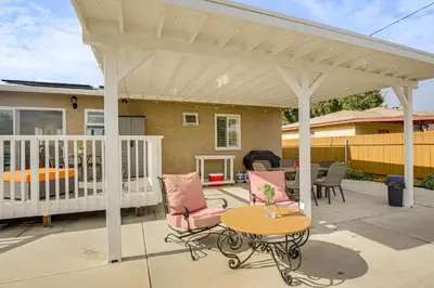 a white pergola on a patio with chairs and a table at Breeze by the Marina Chula Vista Getaway! in Chula Vista