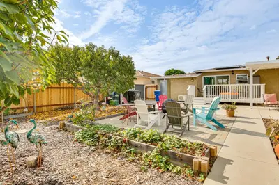 a backyard with a patio with a table and chairs at Breeze by the Marina Chula Vista Getaway! in Chula Vista
