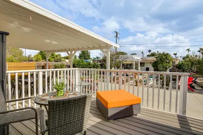 a porch with a table and chairs on a deck at Breeze by the Marina Chula Vista Getaway! in Chula Vista