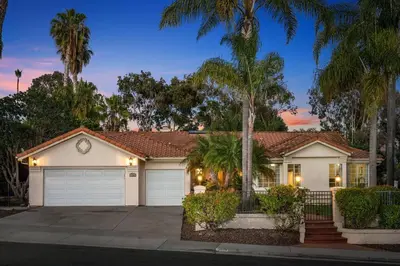 a white house with palm trees in front of it at Mi Casa es Su Casa! (My Home is Your Home!) in Vista