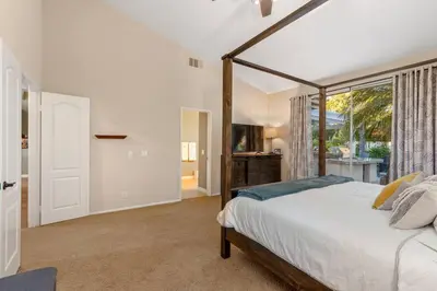 a bedroom with a bed and a large window at Mi Casa es Su Casa! (My Home is Your Home!) in Vista