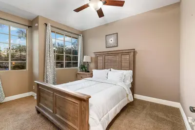 a bedroom with a large bed and a ceiling fan at Mi Casa es Su Casa! (My Home is Your Home!) in Vista