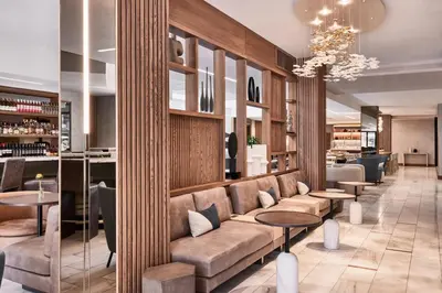 a lobby of a hotel with a couch and tables at AC Hotel by Marriott San Diego Downtown Gaslamp Quarter in San Diego
