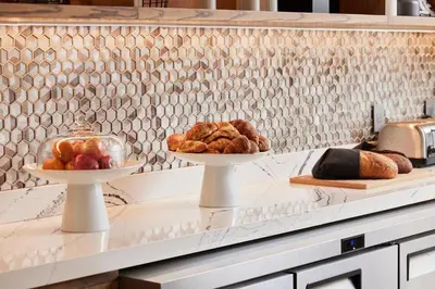 two plates of bread and pastries on a kitchen counter at AC Hotel by Marriott San Diego Downtown Gaslamp Quarter in San Diego