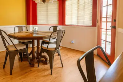 a dining room with a wooden table and chairs at Rosewood Retreat in Hemet