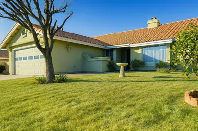 a house with a tree in a yard at Wildflower Haven room in Hemet