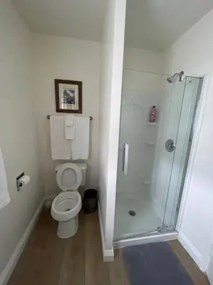 a white bathroom with a shower and a toilet at Blue Whale Inn San Clemente Retreat Unit E in San Clemente