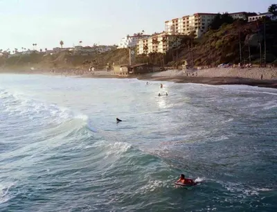 a group of people riding a wave in the ocean at Blue Whale Inn San Clemente Retreat Unit E in San Clemente