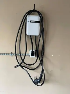 a black cord plugged into an electrical outlet on a wall at Blue Whale Inn San Clemente Charmer Unit A in San Clemente