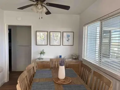 a dining room with a table and a ceiling fan at Blue Whale Inn San Clemente Charmer Unit A in San Clemente