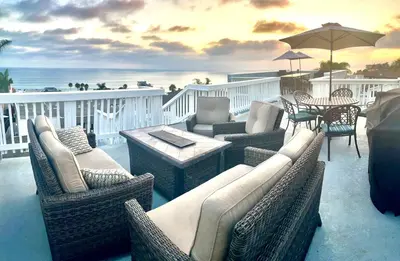 a patio with wicker furniture and a table and chairs at Blue Whale Inn San Clemente Jewel Unit D in San Clemente