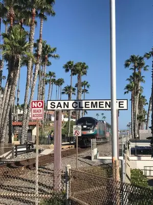 a train on a track with palm trees and a street sign at Blue Whale Inn San Clemente Jewel Unit D in San Clemente