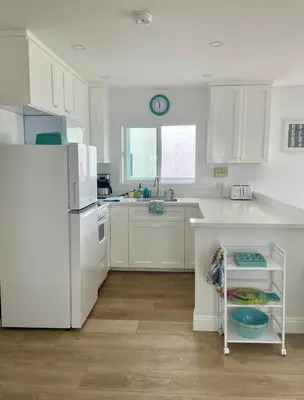 a kitchen with white cabinets and a white refrigerator at Blue Whale Inn San Clemente Jewel Unit D in San Clemente